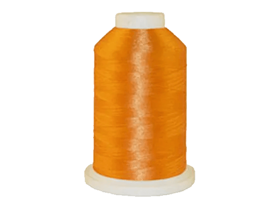 Brother orange embroidery thread spool on white background