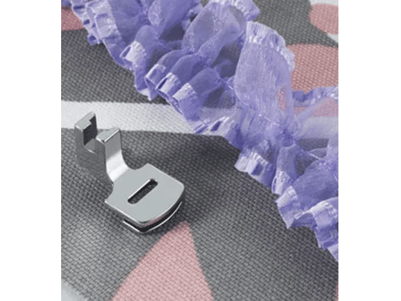 Brother gathering foot attachment creating ruffled purple fabric on textured gray material