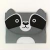 Gray raccoon-shaped folder with black eye patches and smiling face on white background