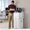 Man reviewing color document from Brother HL-L9470CDN laser printer in office