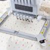 Brother embroidery machine with multi-needle system stitching colorful pattern on fabric