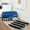 Brother TN223 4-pack color toner cartridges displayed with packaging and wireless printer