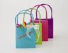 Colorful gift bags with Brother label maker tape showing personalized birthday message