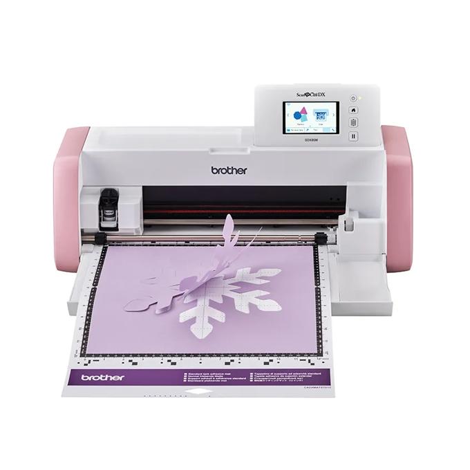 Brother ScanNCut cutting machine with touchscreen creating purple snowflake design on cutting mat