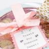 Brother TZe-M51 label tape on gift tag with pink ribbon and cookies in jar