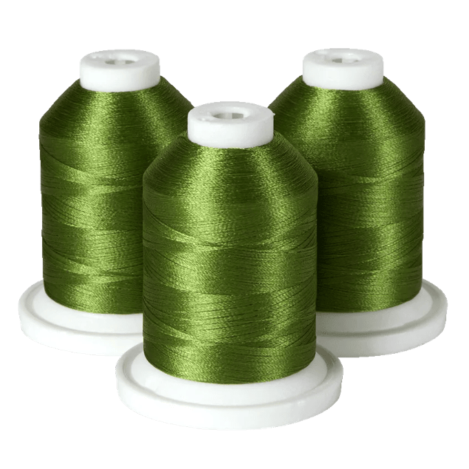 Three spools of green embroidery thread on white bases
