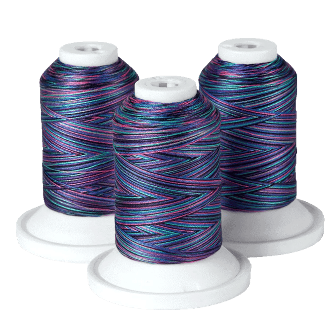 Brother multi-colored embroidery thread spools with variegated blue, purple, and pink tones