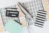 Organized workspace with labeled folders, stainless steel water bottle, and personalized stationery
