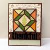 Handmade thankful card with autumn quilt pattern and leaf design in orange and green tones