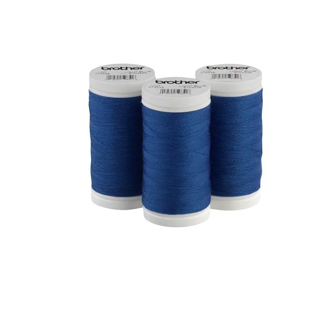 Three Brother blue polyester thread spools with white caps on white background