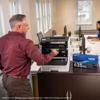 Man replacing toner cartridge in Brother HL-L8430CDWT color laser printer in office