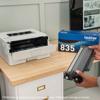 Brother HL-L2865DW wireless monochrome laser printer with user holding toner cartridge