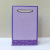 Purple gift bag with chevron pattern and star design at bottom