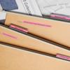 Brother P-touch label maker organizing wooden desk drawer with labeled dividers and fabric swatches