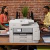 Brother MFC-J5955DW all-in-one inkjet printer with touchscreen on office desk with two coworkers