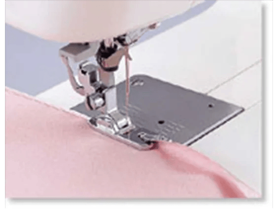 Brother sewing machine presser foot stitching pink fabric with white thread