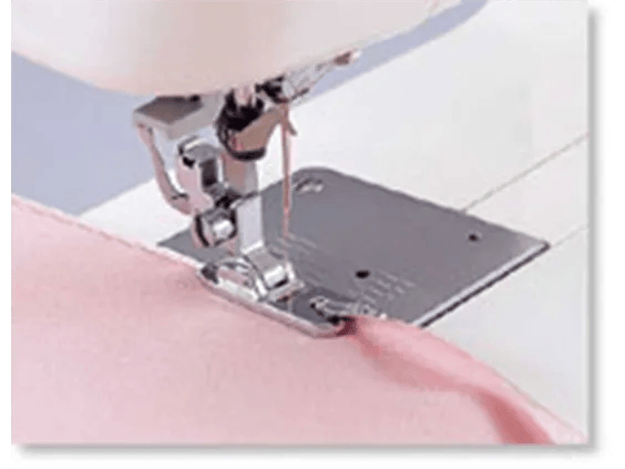 Brother sewing machine presser foot stitching pink fabric with white thread
