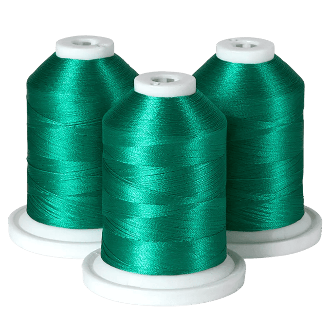 Three spools of emerald green embroidery thread on white bases