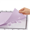 Hand peeling purple cut paper from Brother cutting mat with ruler markings