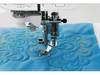 Brother sewing machine quilting foot stitching decorative swirl pattern on blue fabric