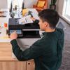 Man using Brother all-in-one color laser printer with touchscreen in home office