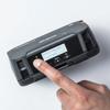 Brother RJ4230BL mobile printer with hand pressing menu button showing battery health display