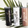 Three personalized insulated tumblers with custom names in black, marble, and rose gold finishes