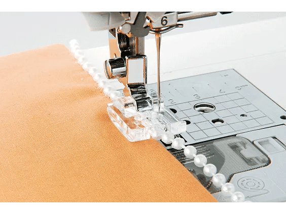 Brother sewing machine stitching peach fabric with clear presser foot and needle plate