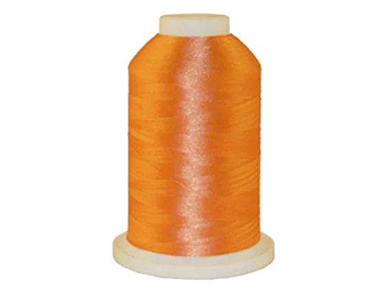 Brother orange embroidery thread spool on white background