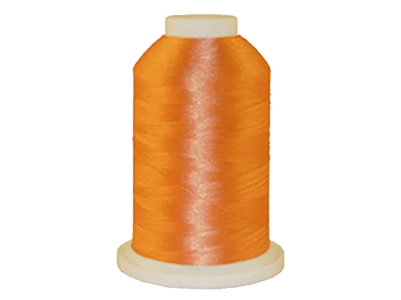Brother orange embroidery thread spool on white background