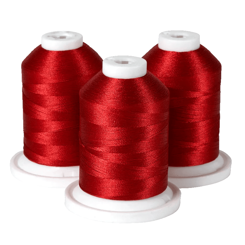 Three spools of red embroidery thread on white bases for Brother sewing machines