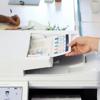 Hand retrieving infographic from Brother MFC-L9610CDN color laser all-in-one printer output tray