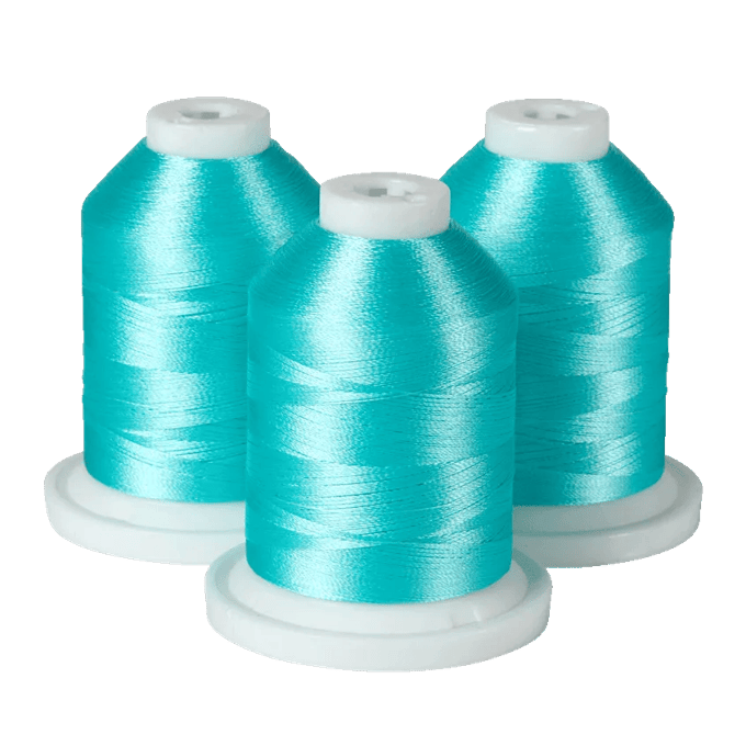 Three turquoise embroidery thread spools on white bases