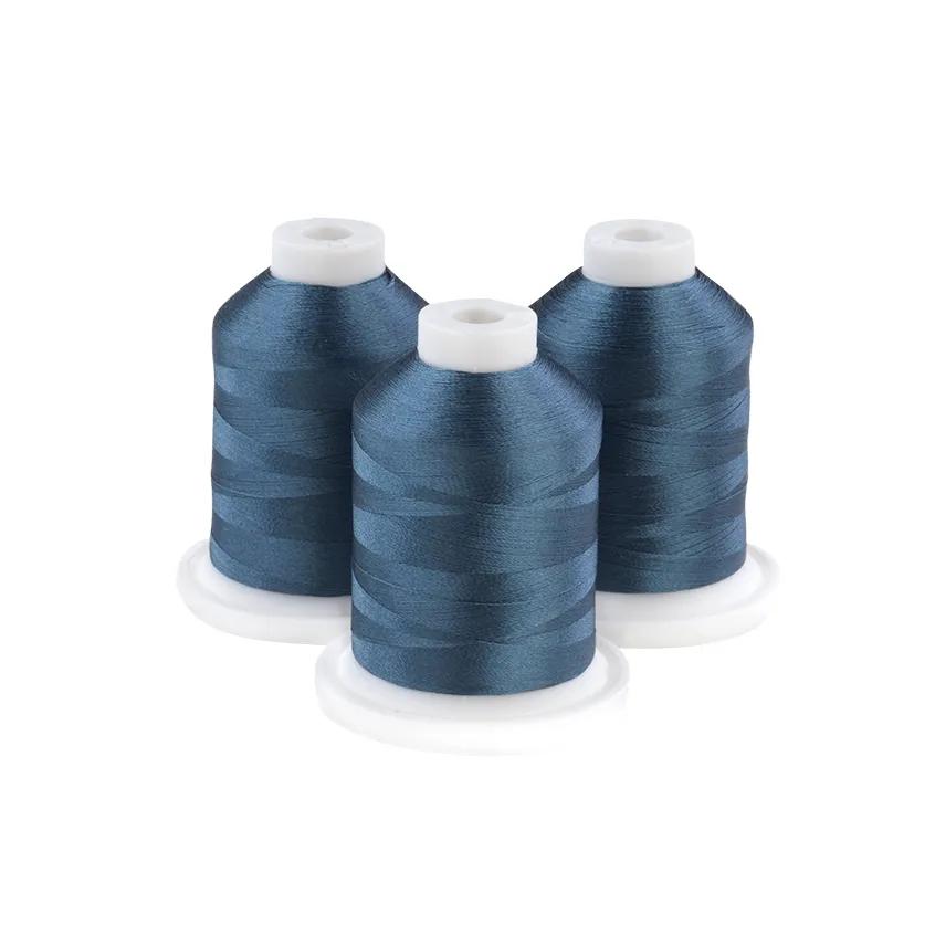 Three spools of Brother embroidery thread in grey-aqua blue on white bases
