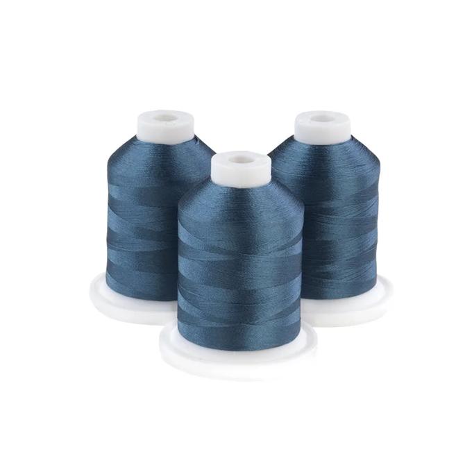 Three spools of Brother embroidery thread in grey-aqua blue on white bases