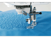 Brother sewing machine quilting foot stitching decorative pattern on blue fabric