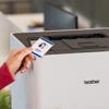 Hand scanning ID badge on Brother HL-L8430CDWT color laser printer with secure print feature