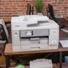 Brother MFC-J6955DW A3 color inkjet all-in-one printer on office desk with dual paper trays
