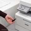 Hand inserting USB drive into Brother MFC-L8395CDW color laser all-in-one printer