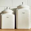 Brother TZe-231 label tape on white ceramic kitchen canisters for flour and sugar