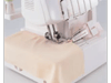 Brother serger sewing machine stitching beige fabric with cover stitch attachment