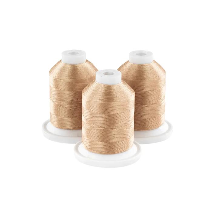 Three gold embroidery thread spools on white bases for sewing and crafting