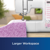 Brother sewing machine with purple floral fabric on wooden table in bright workspace