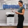 Woman reviewing document printed from Brother MFC-L5717DW all-in-one laser printer in office