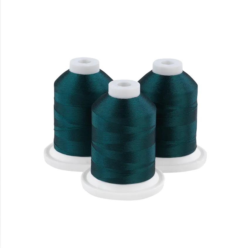Three dark lagoon embroidery thread spools on white bases