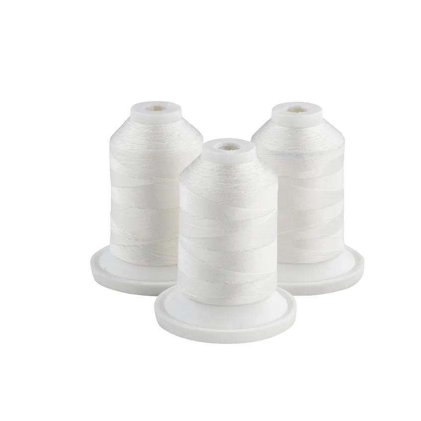 Three white embroidery thread spools on white bases for sewing machines