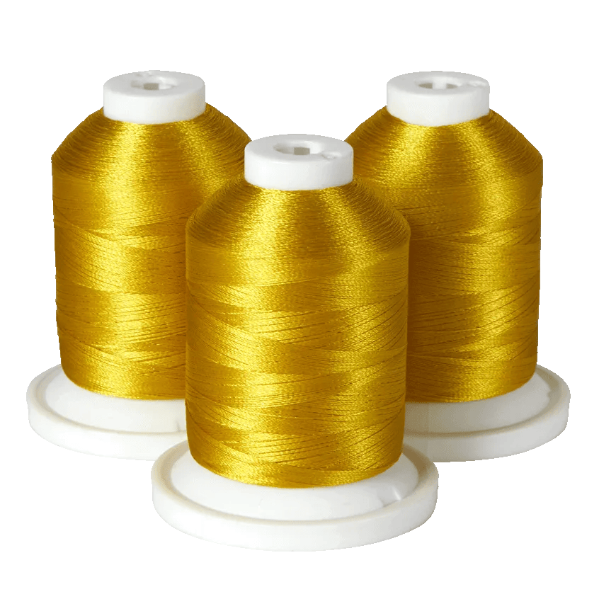 Three spools of gold embroidery thread on white bases for Brother sewing machines