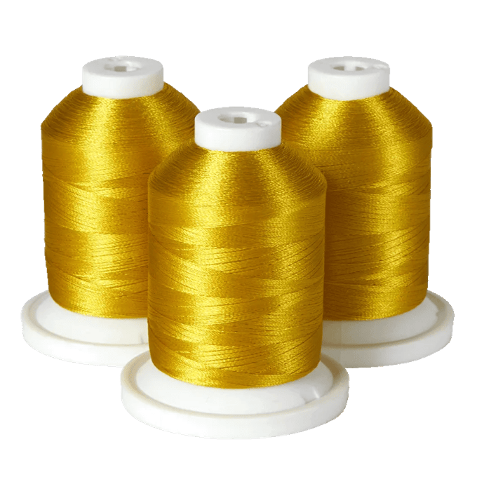 Three spools of gold embroidery thread on white bases for Brother sewing machines