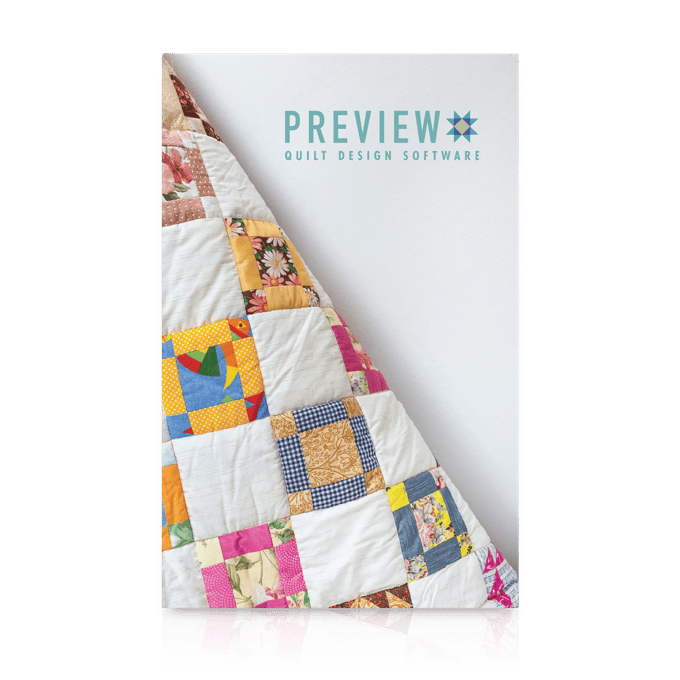 Colorful patchwork quilt with floral and geometric patterns displayed on white background