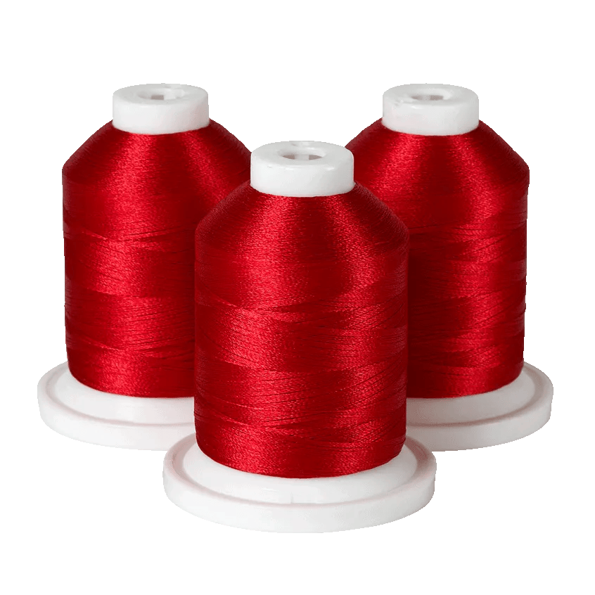 Three spools of red embroidery thread on white bases for Brother sewing machines